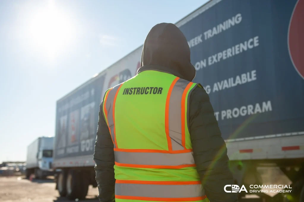 Backside view of CDA instructor facing semi truck trailer