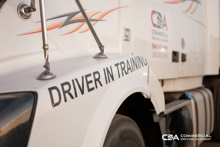 Closeup of "Driver in Training" sticker on tractor trailer cab