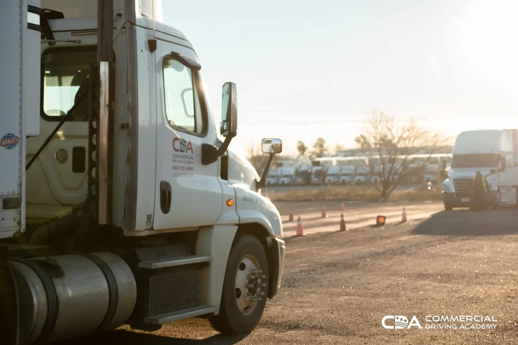 Two CDA semi trucks facing each other in training yard. Diagonal view.