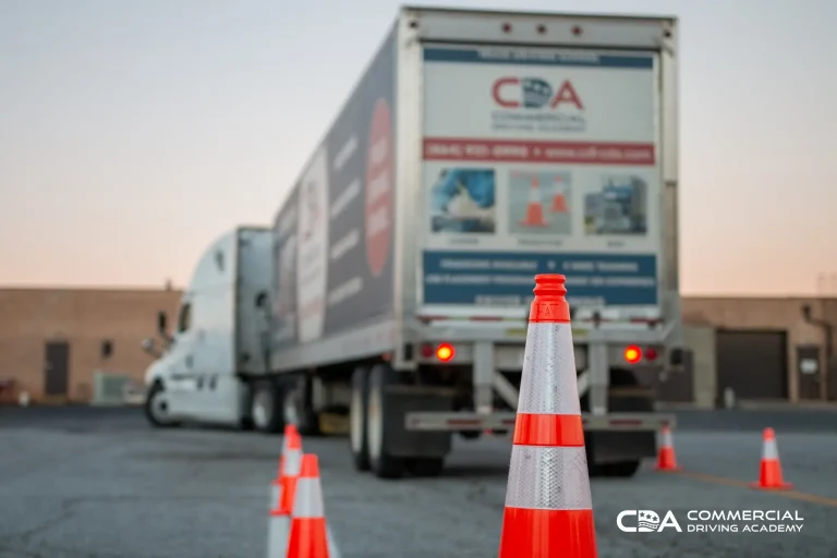 Focus on cones in training yard, CDA semi truck blurred out in background