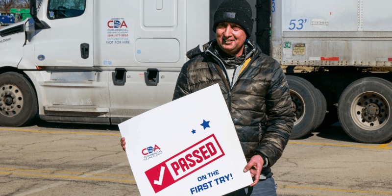 CDA graduate holding up a "I passed!" sign