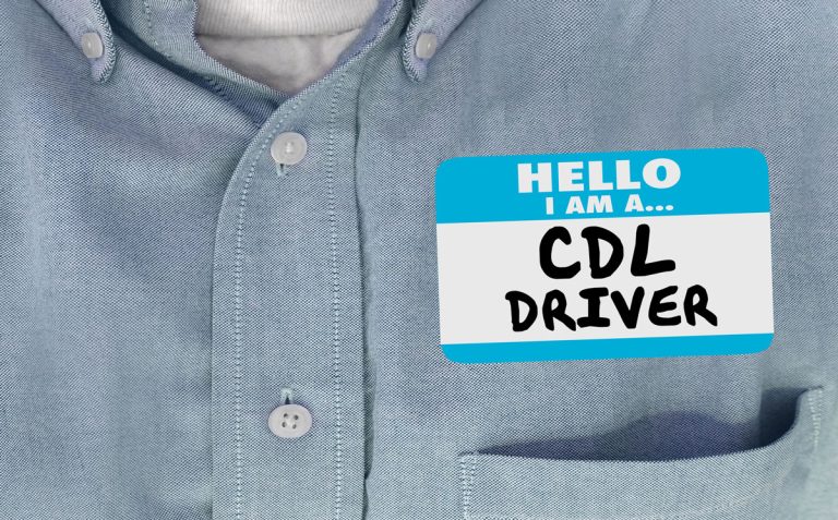 Blue button up shirt with name tag that says "Hello I am a CDL Driver"